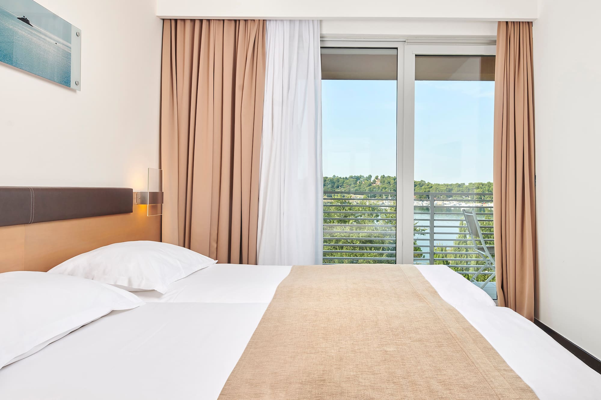 a bed with a window and curtains