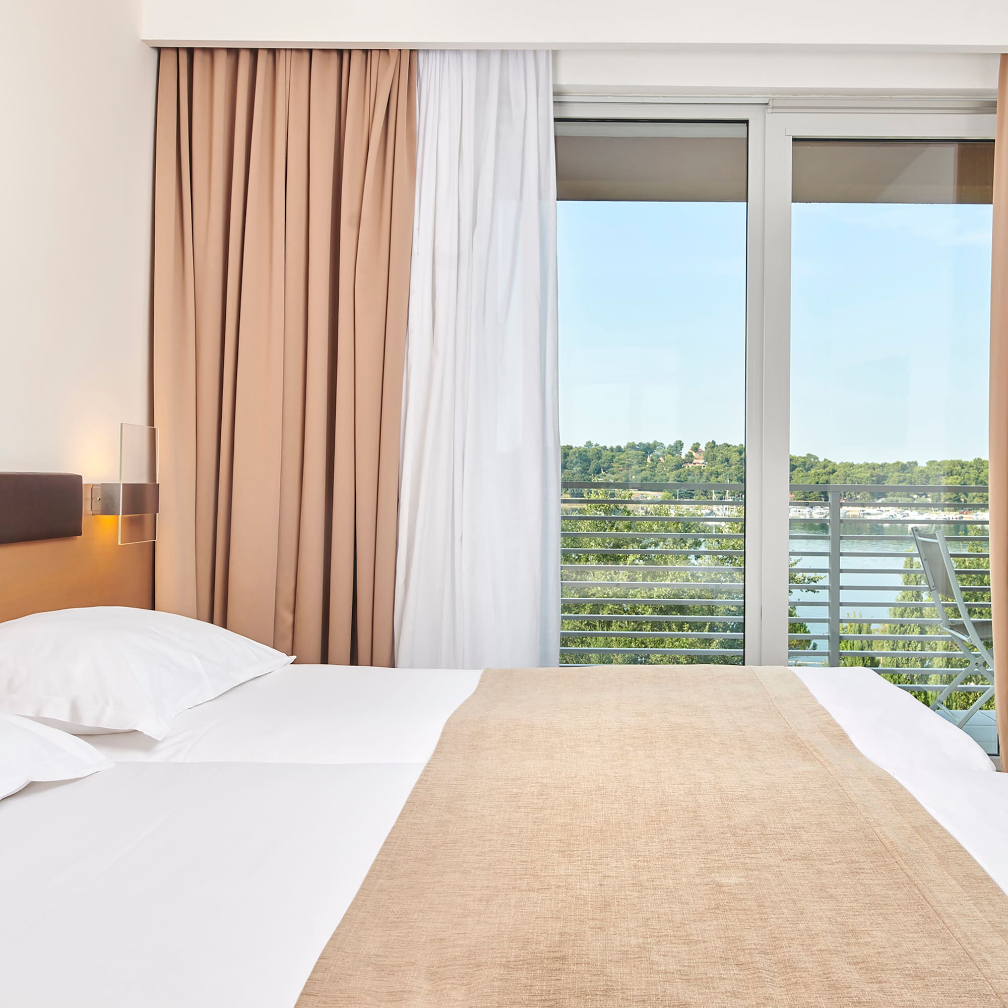 a bed with a window and curtains