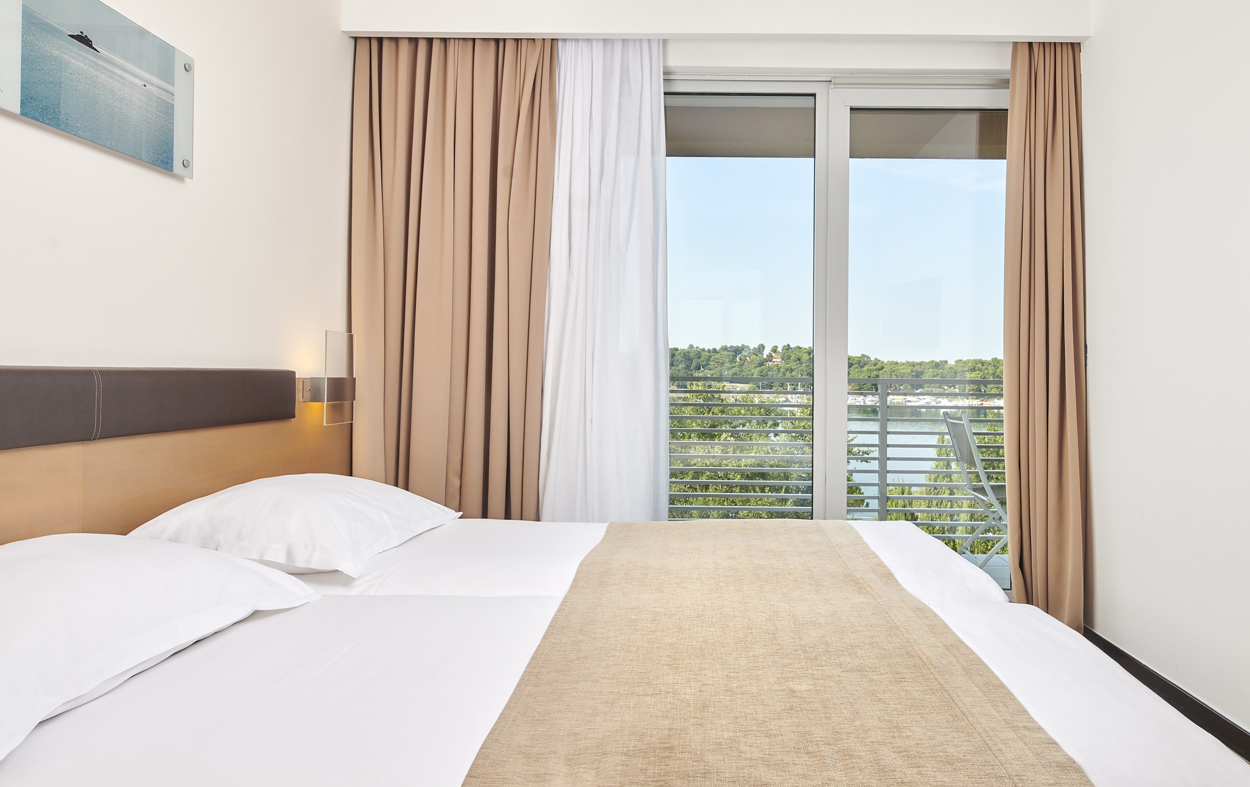 a bed with a window and curtains