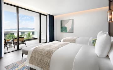 a bedroom with a chair and a bed