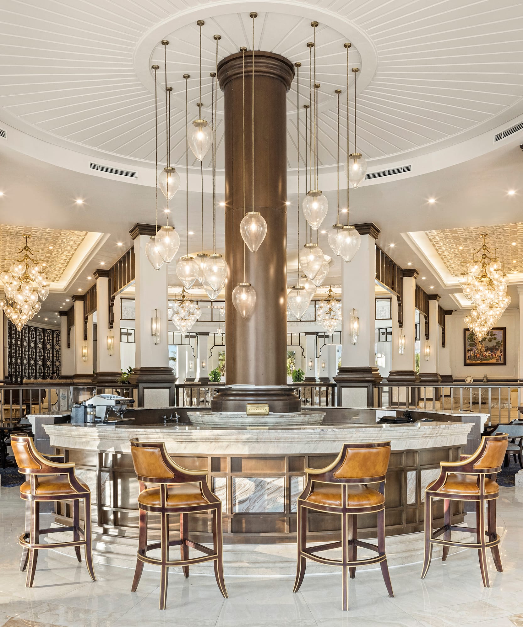 a large round table with chairs and chandeliers in a room