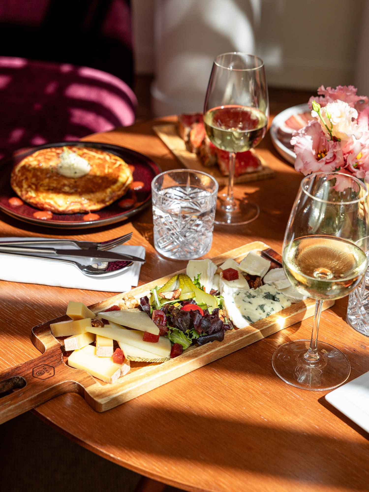 a table with food and glasses of wine