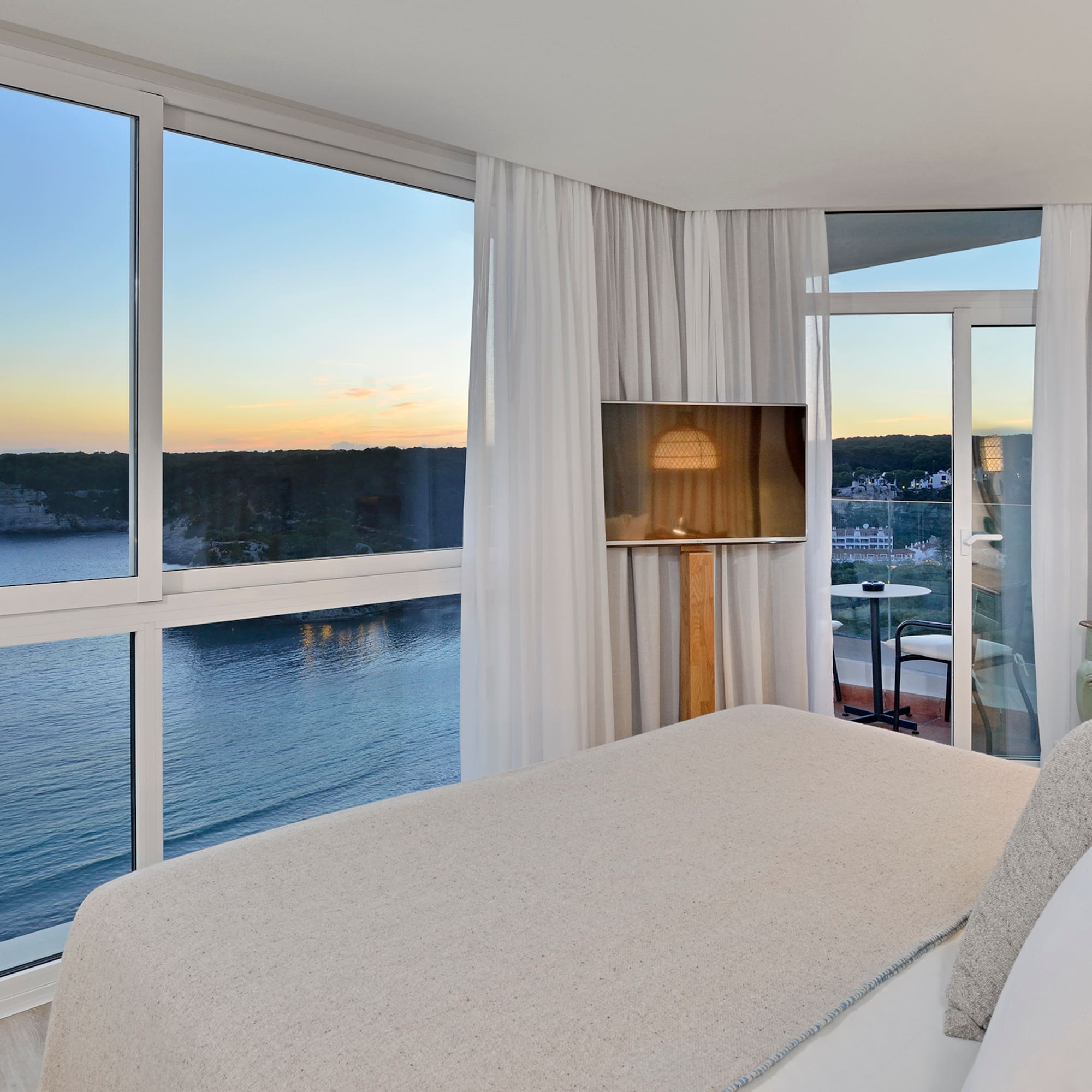 a bedroom with a view of the ocean and a window