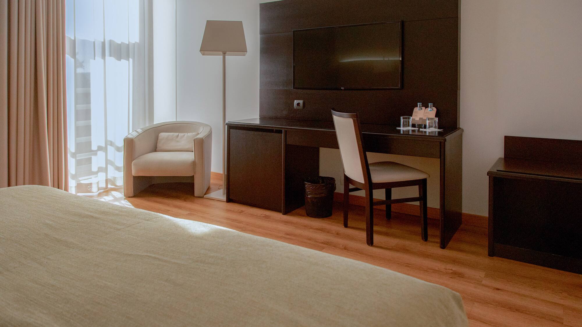 a room with a bed and a tv