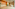 Modern hotel lobby, wood slat walls, long sofa, marble floor, reception desk.