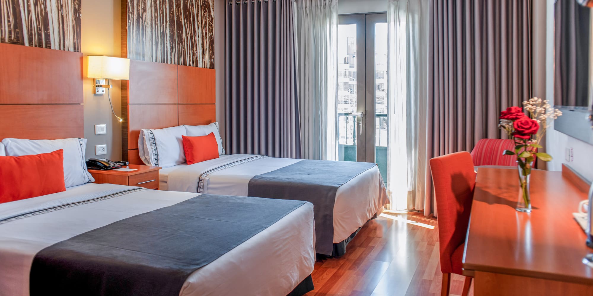 a room with two beds and a red chair