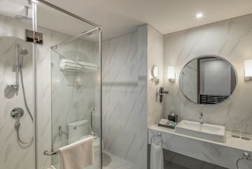 a bathroom with a mirror and a shower