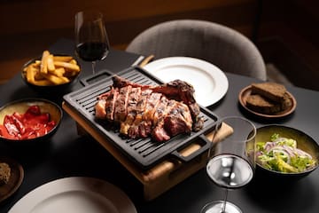 a steak on a grill with food on it