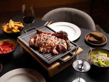 a steak on a grill with food on it