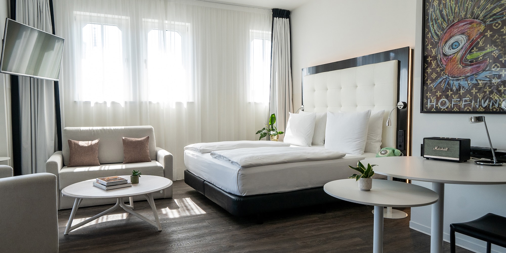 a bedroom with a bed and couches