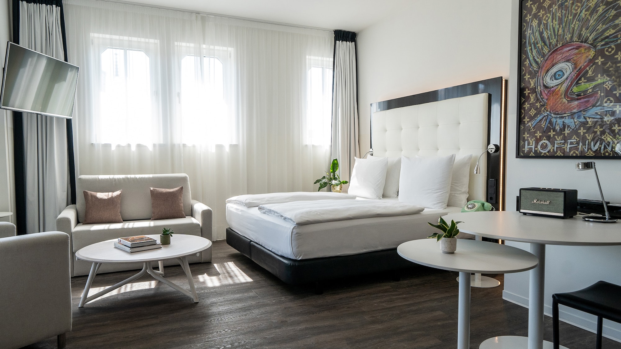 a bedroom with a bed and couches