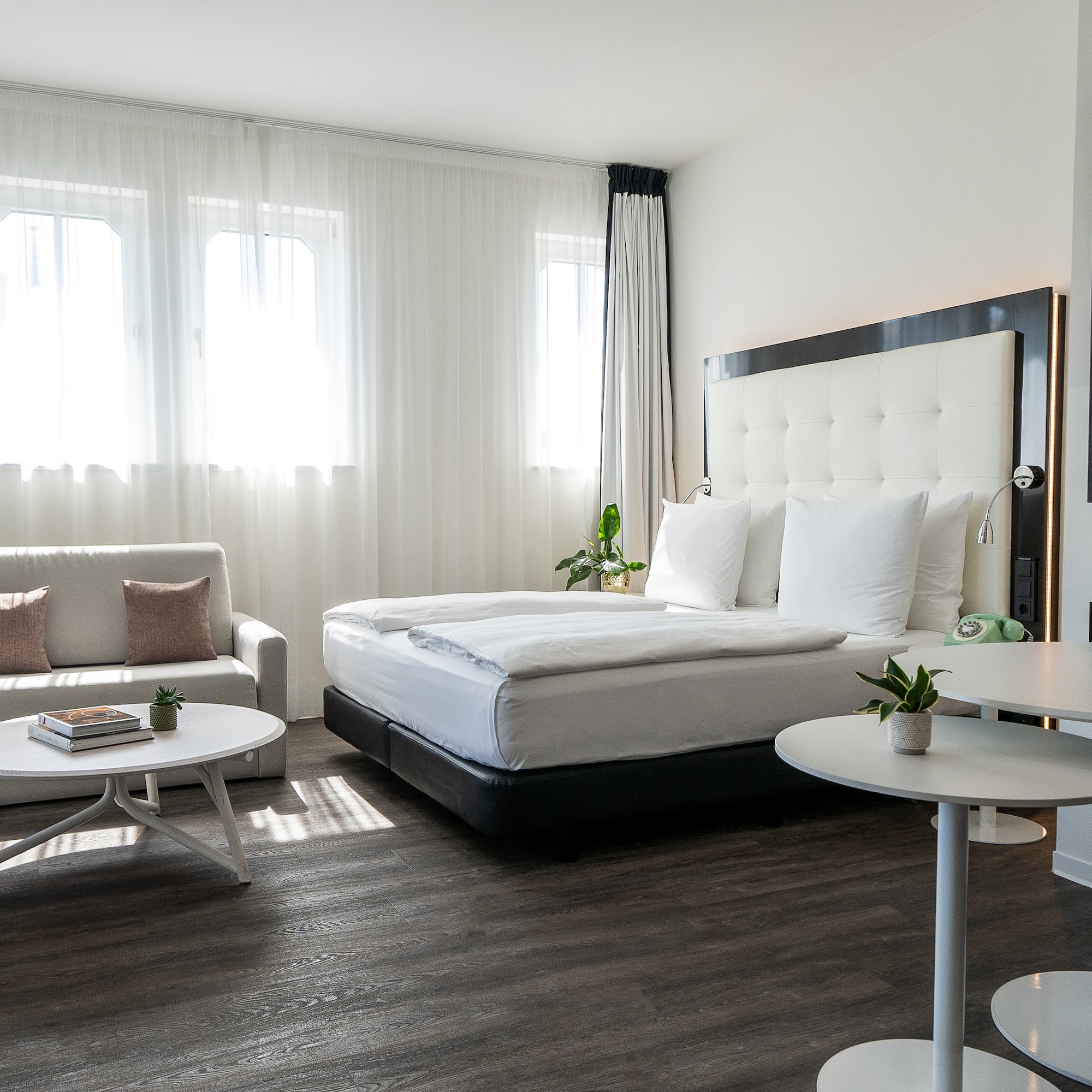 a bedroom with a bed and couches