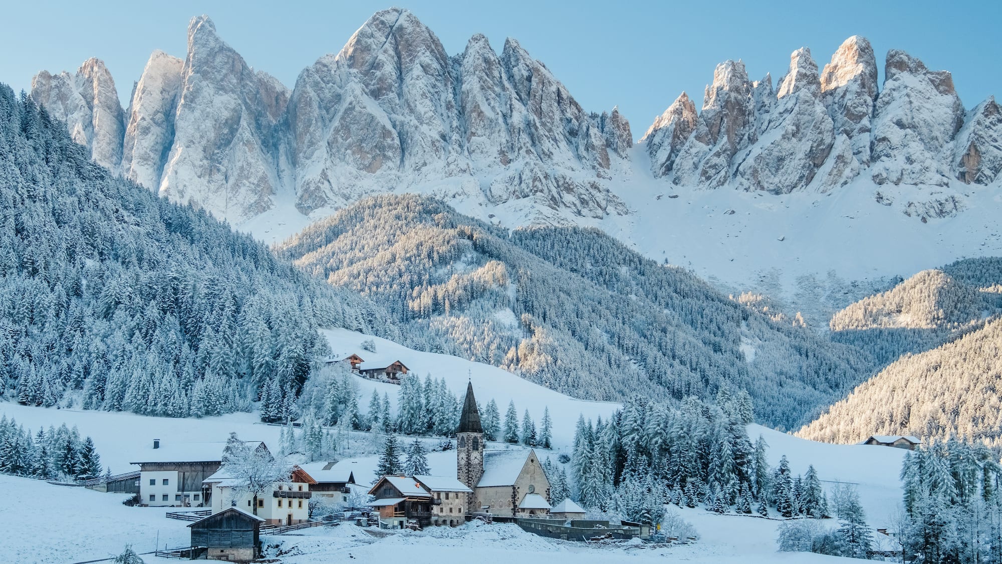 a snowy mountain with a village in the background
