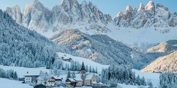 a snowy mountain with a village in the background