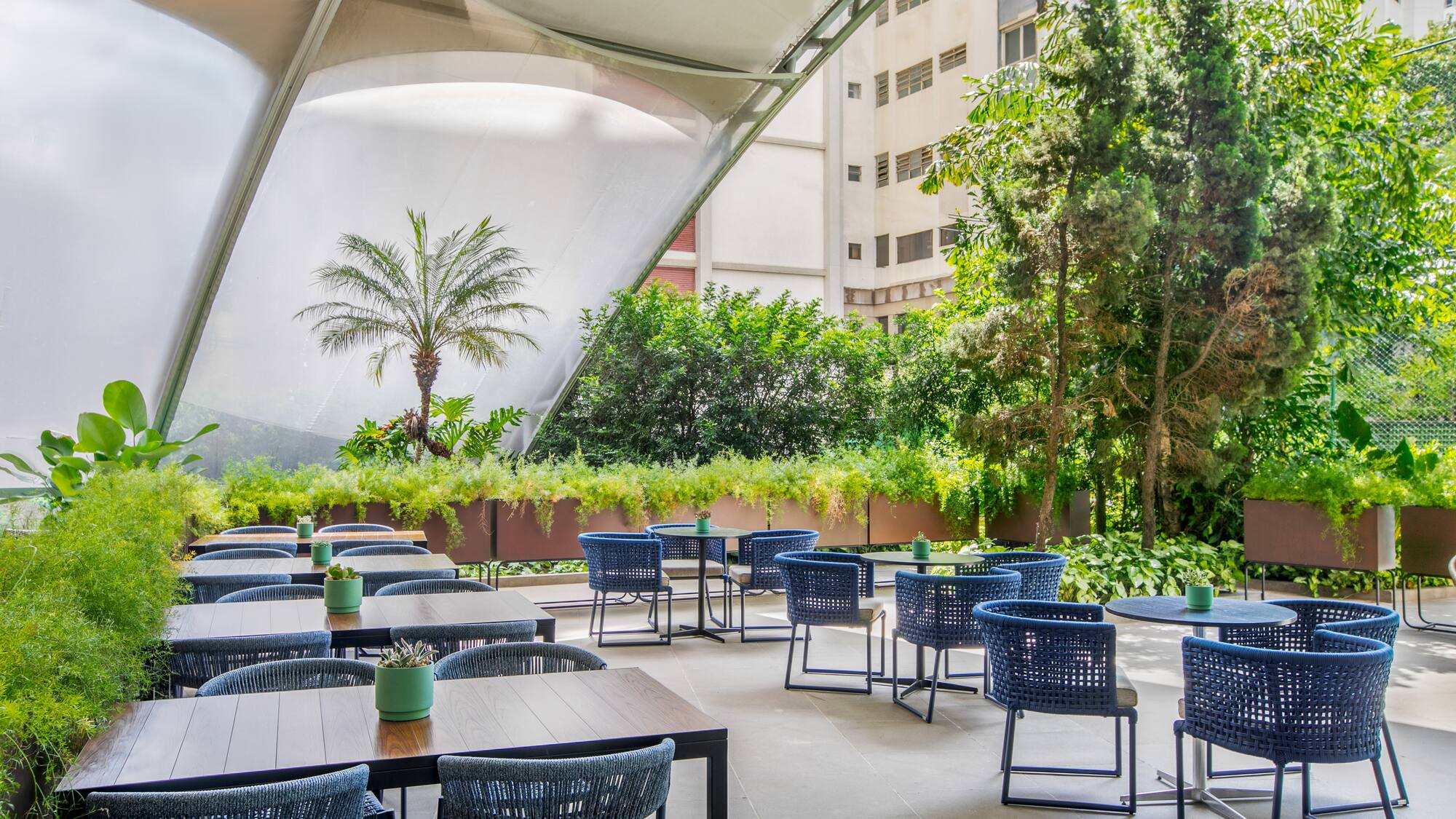 a patio with tables and chairs