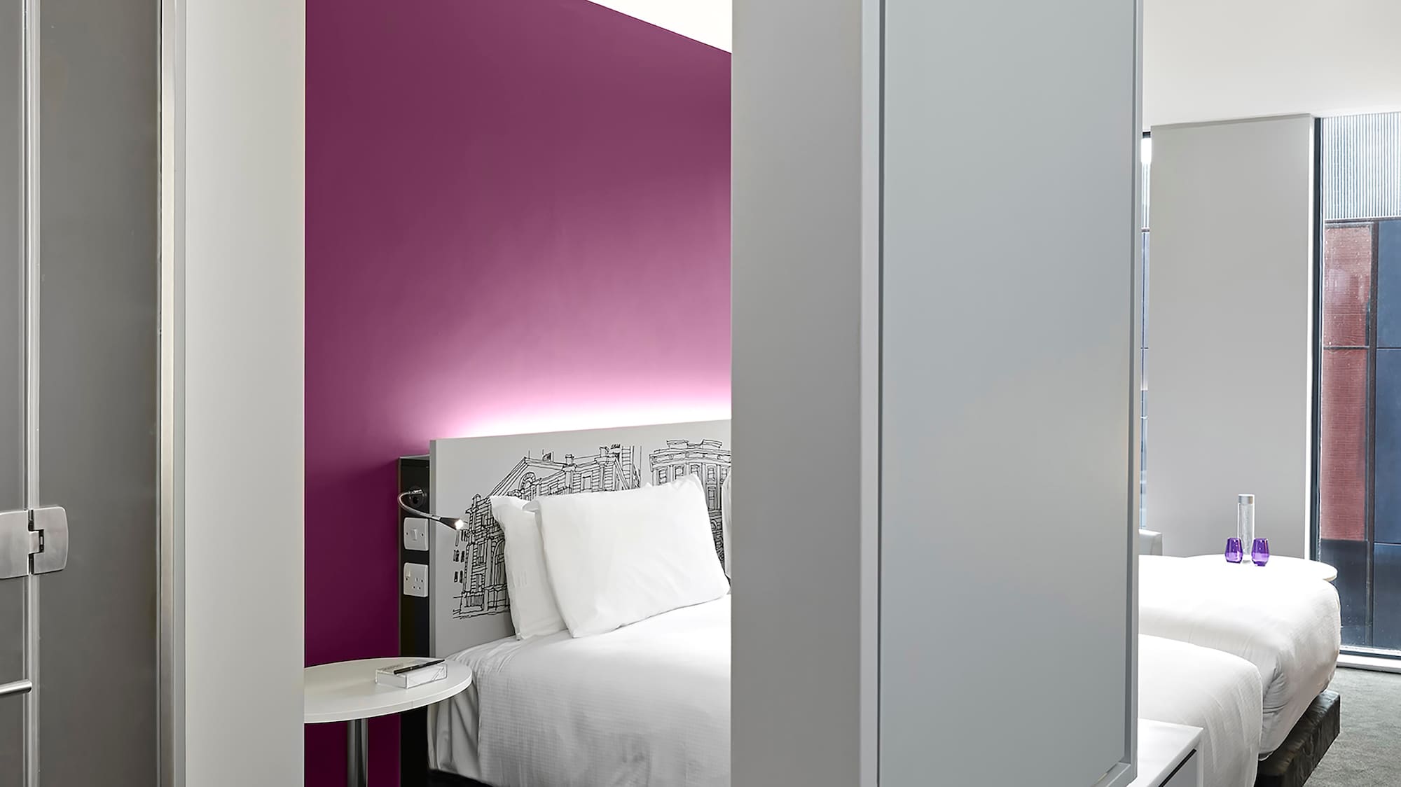 a room with a bed and a mirror