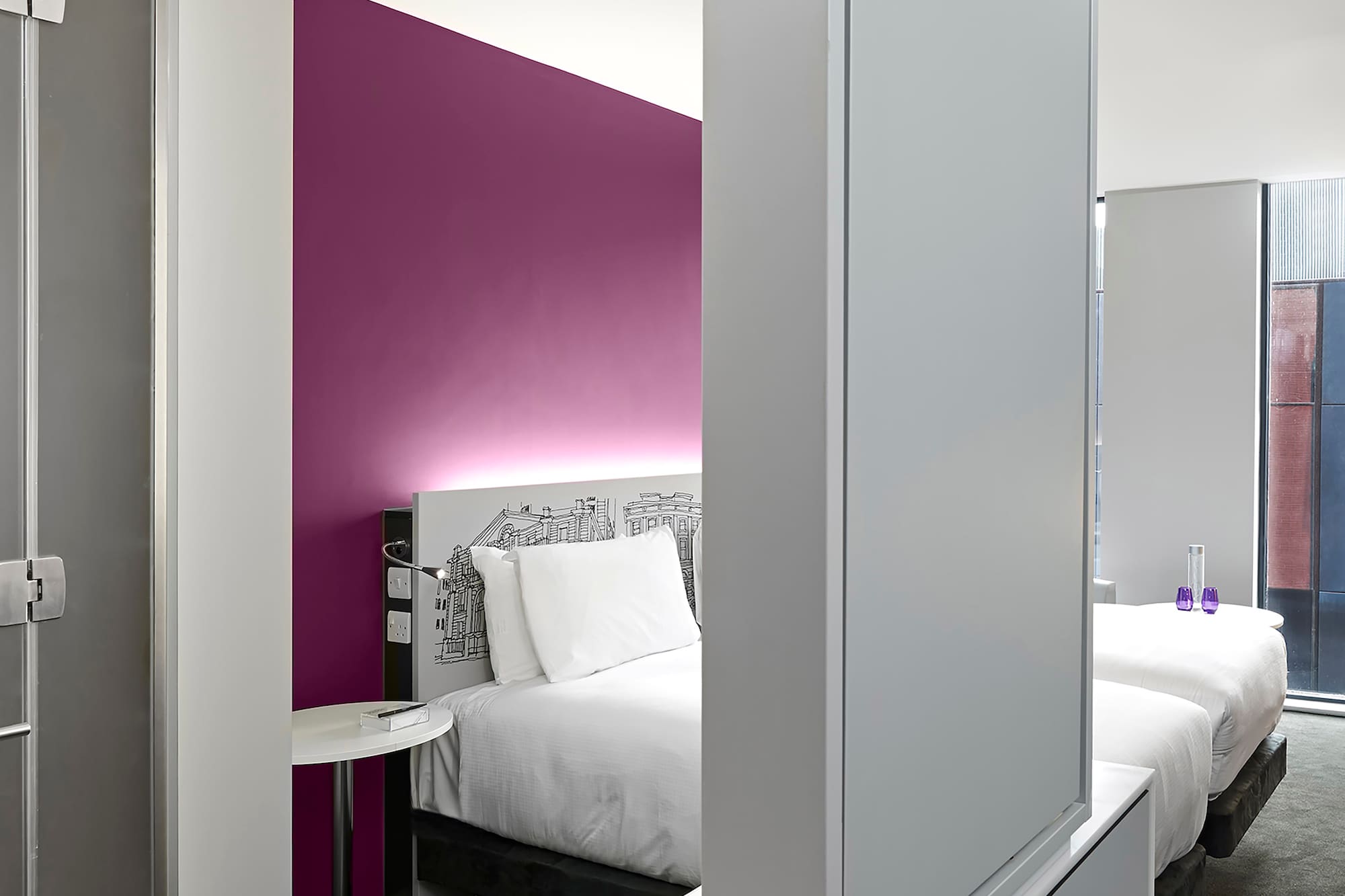 a room with a bed and a mirror