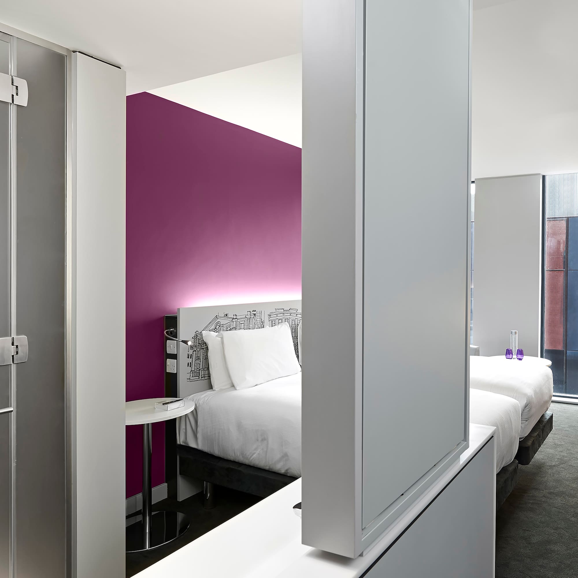 a room with a bed and a mirror