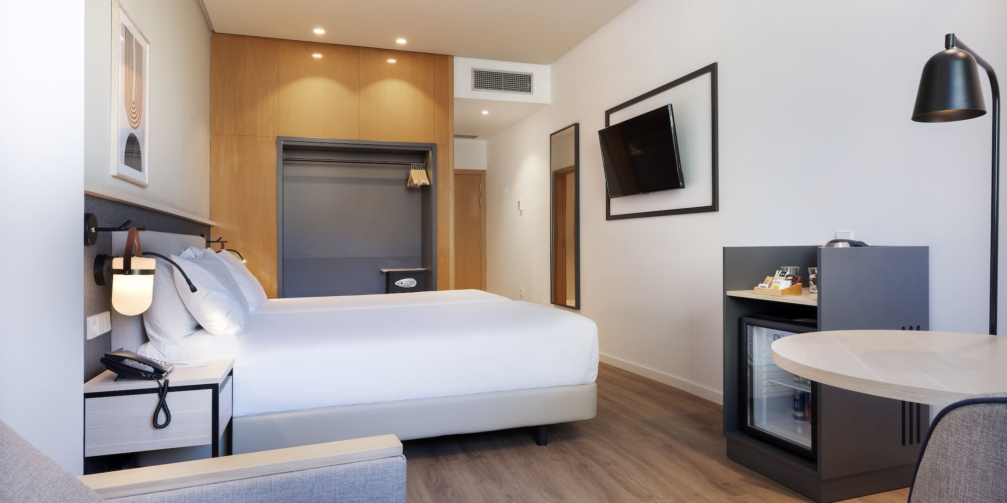 a room with a bed and a television