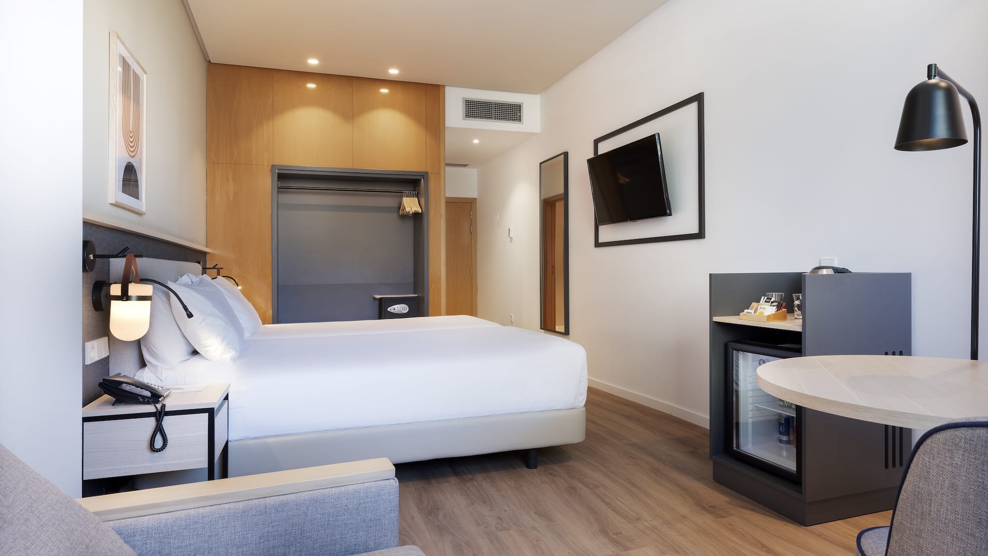 a room with a bed and a television