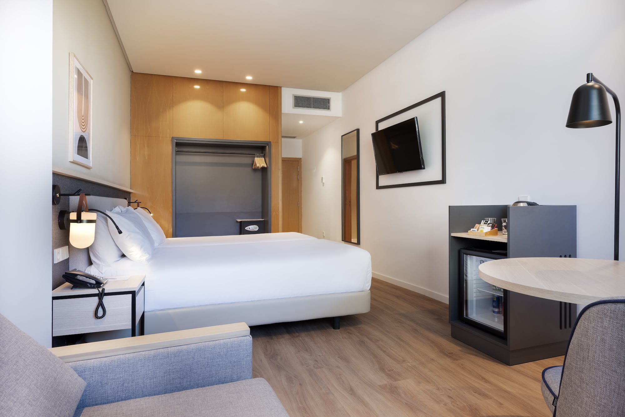 a room with a bed and a television