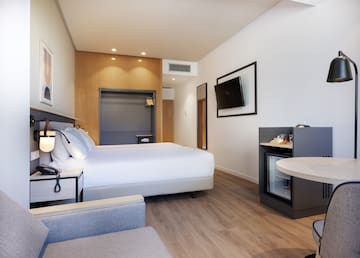 a room with a bed and a television