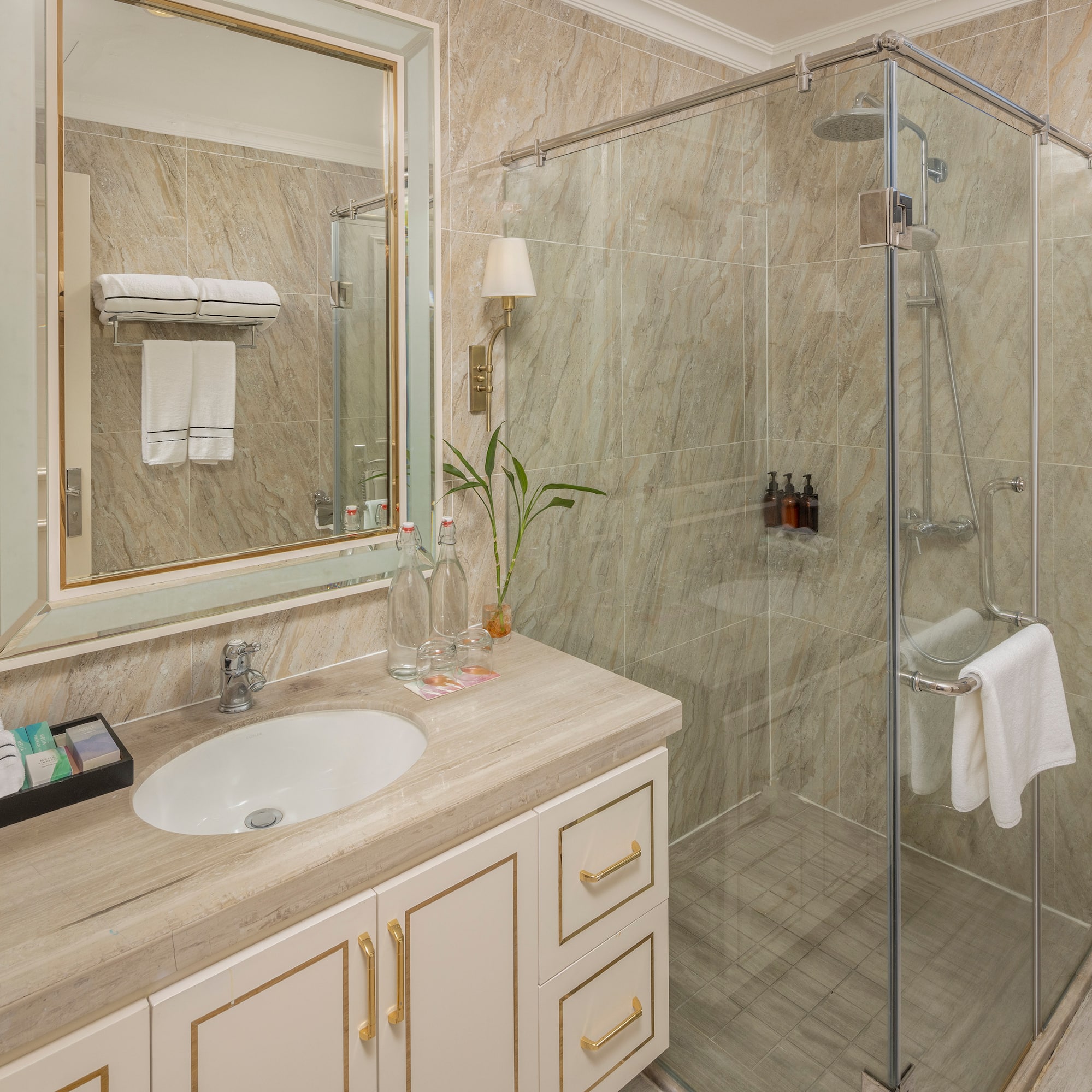 a bathroom with a glass shower and sink