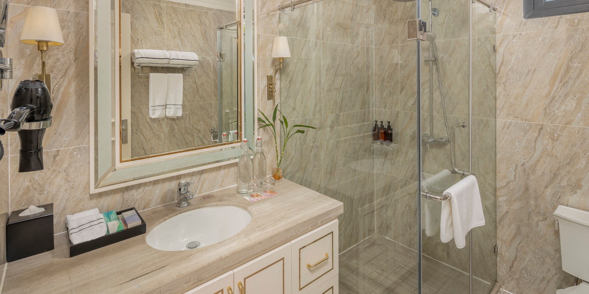a bathroom with a glass shower and sink