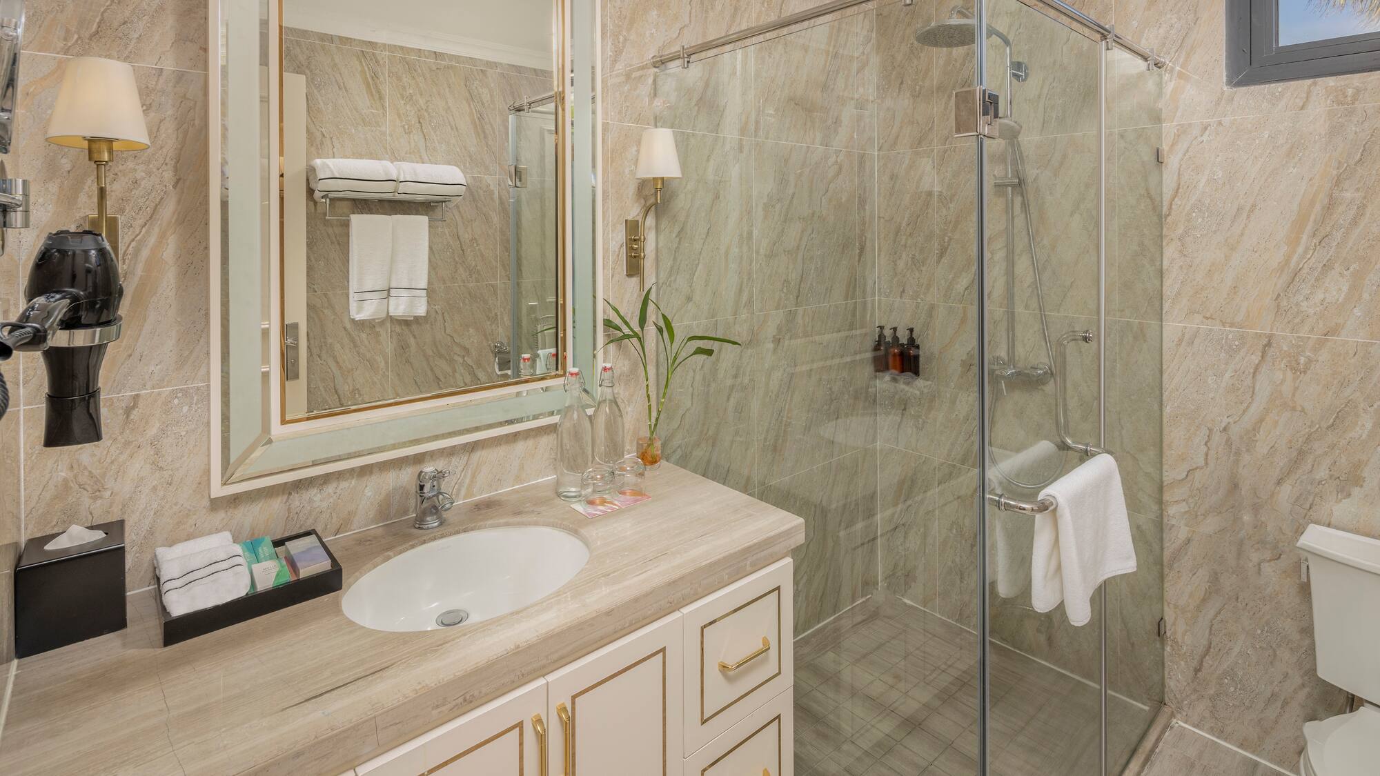a bathroom with a glass shower and sink