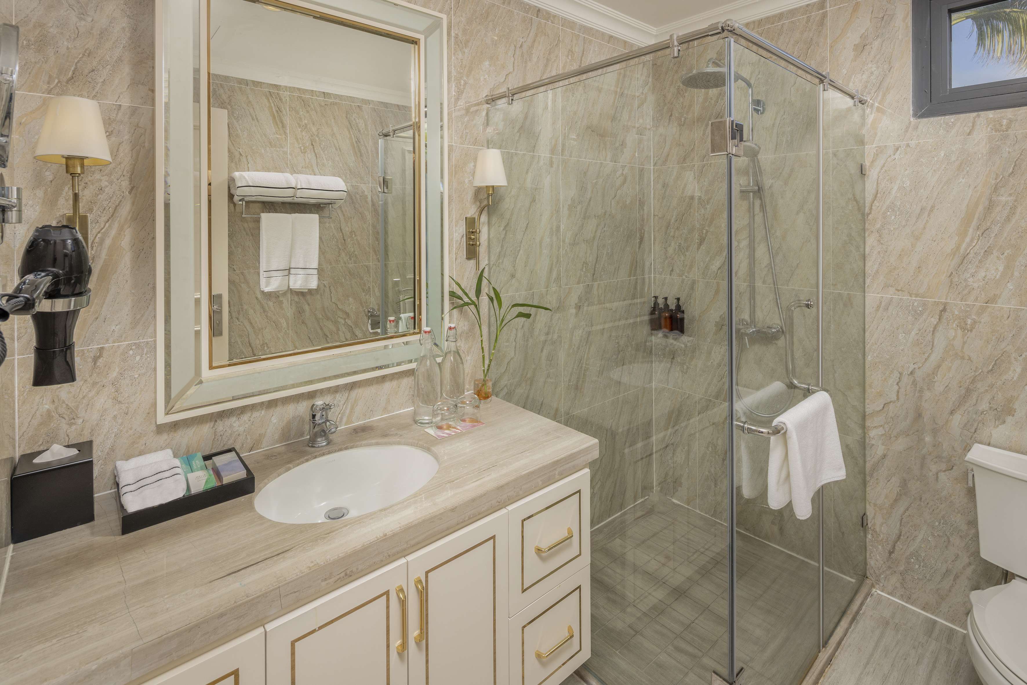 a bathroom with a glass shower and sink