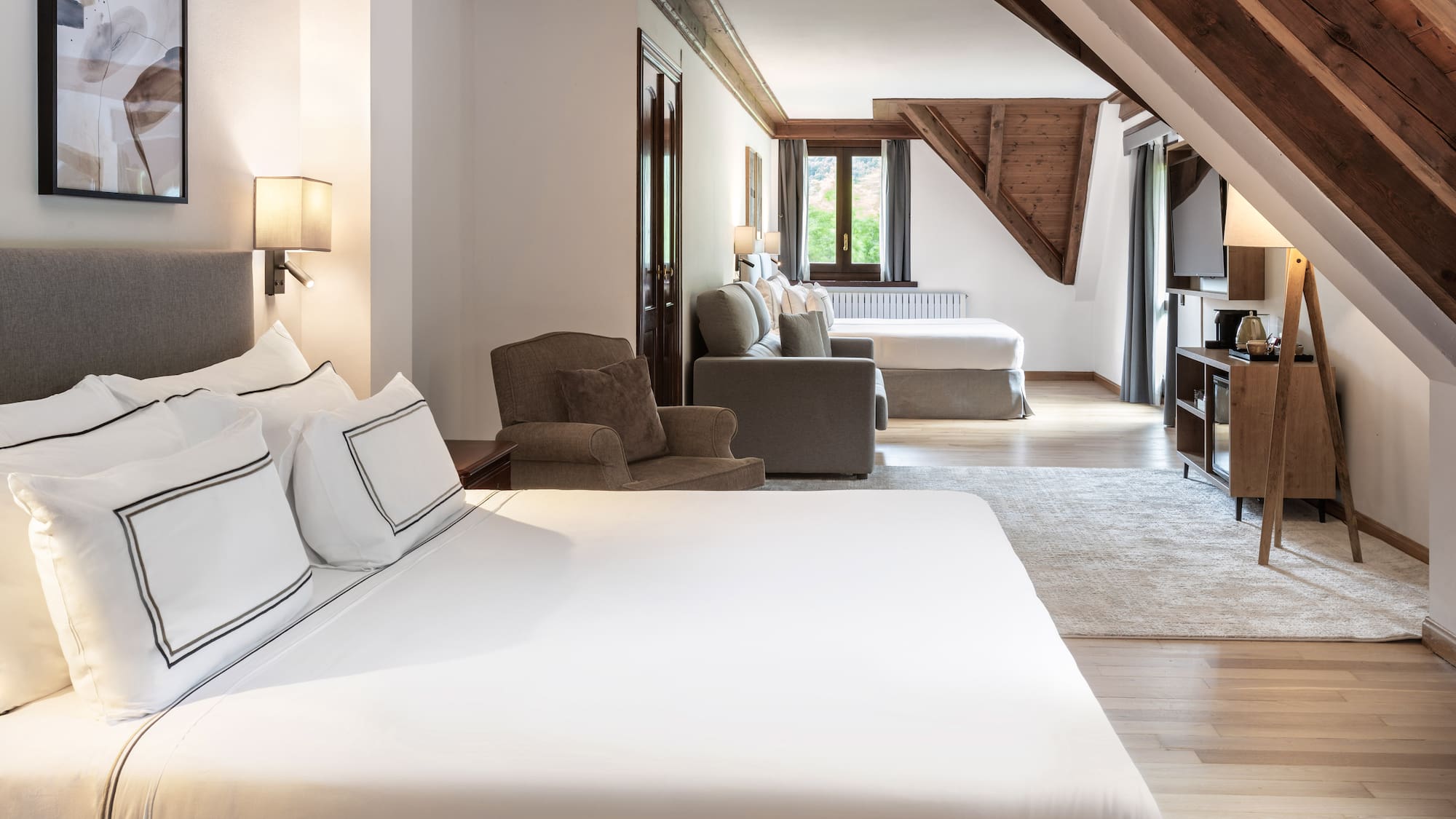 a room with a bed and a television