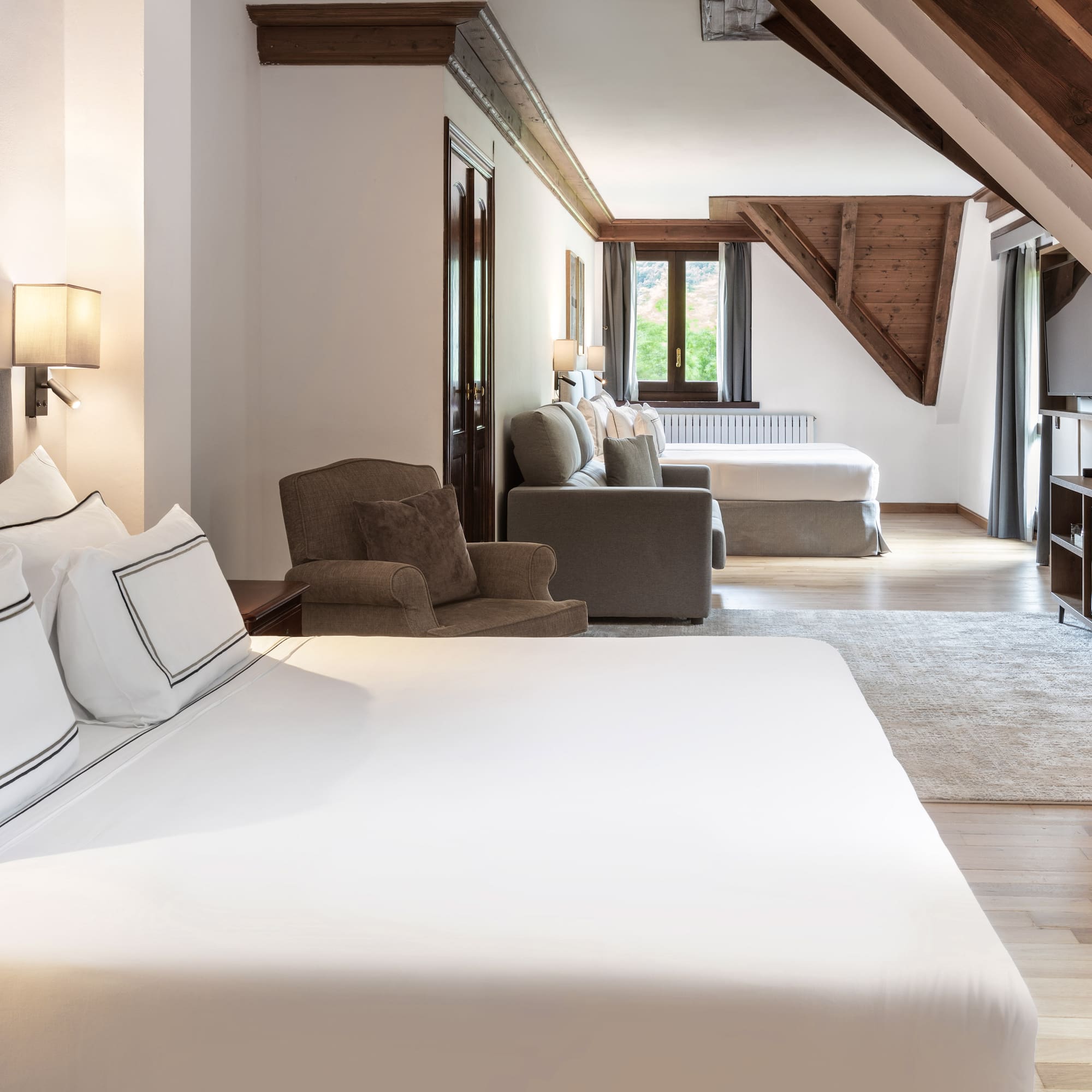 a room with a bed and a television