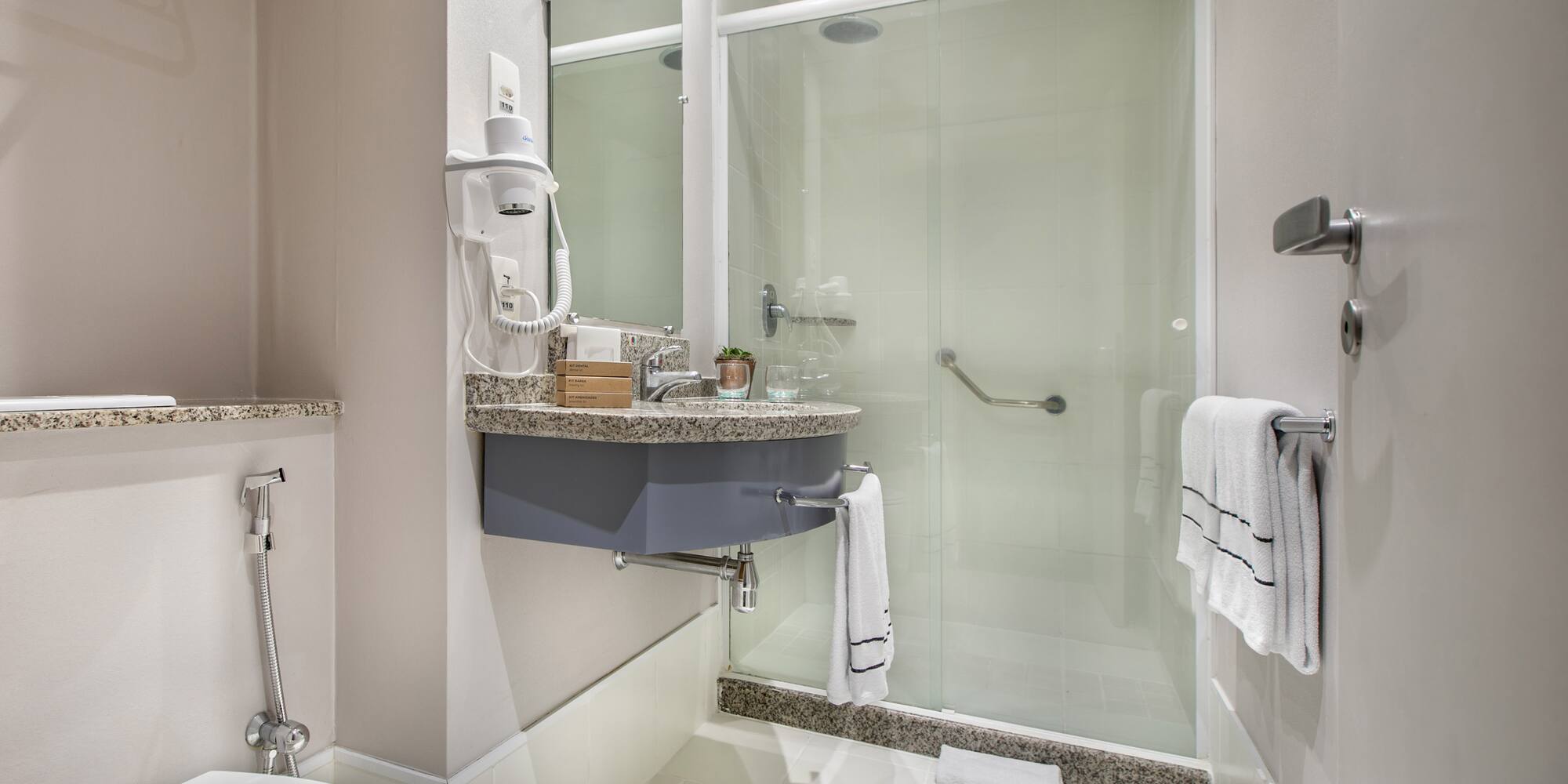 a bathroom with a glass shower door