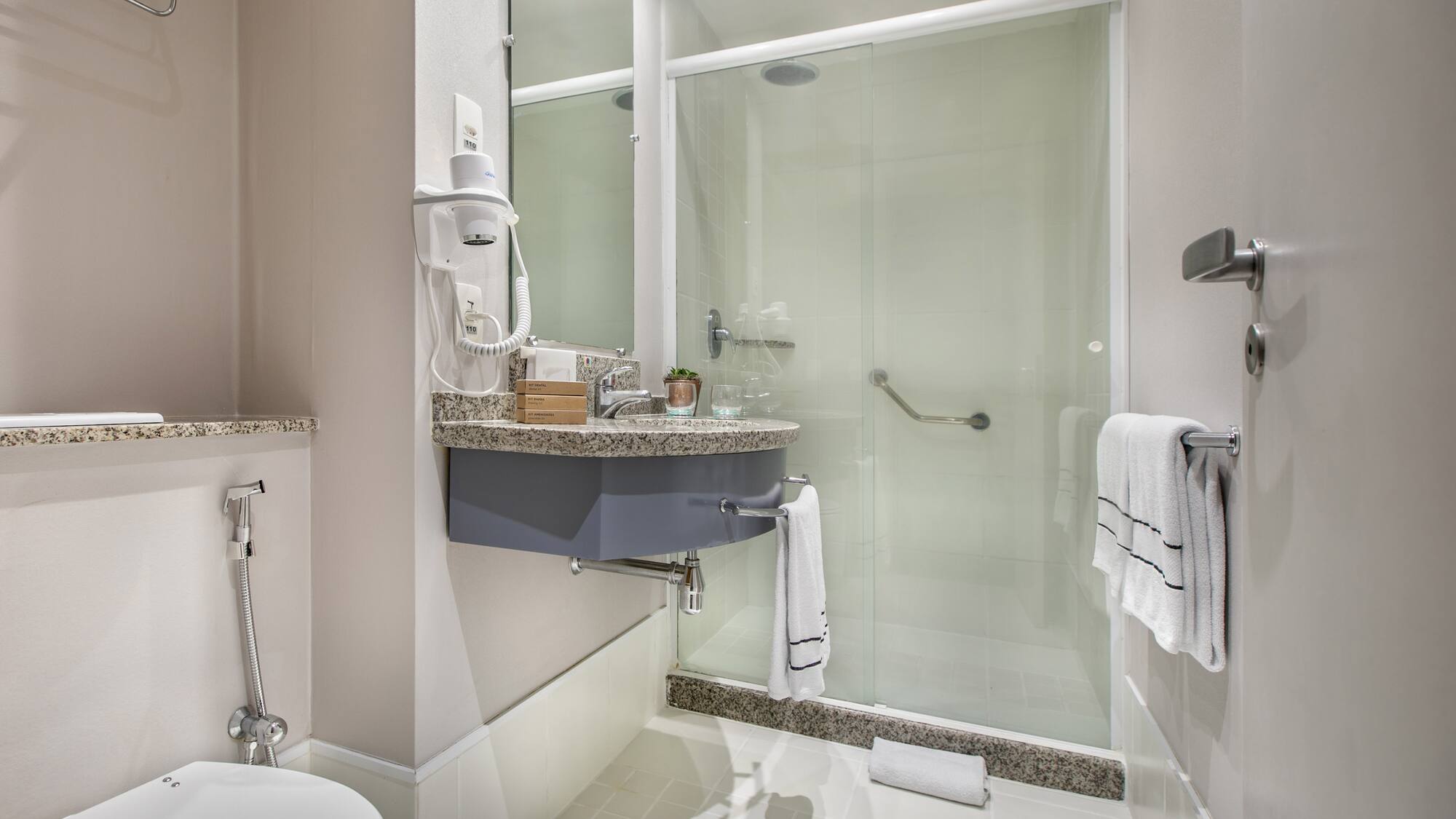 a bathroom with a glass shower door