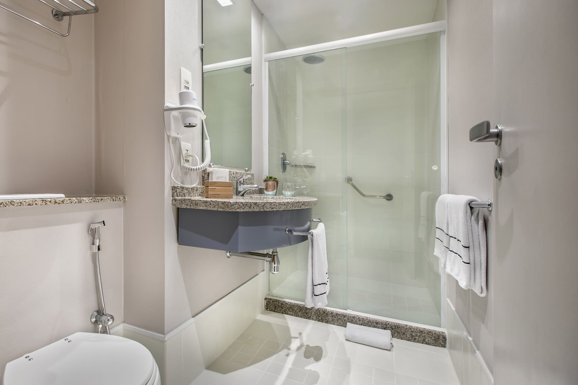 a bathroom with a glass shower door
