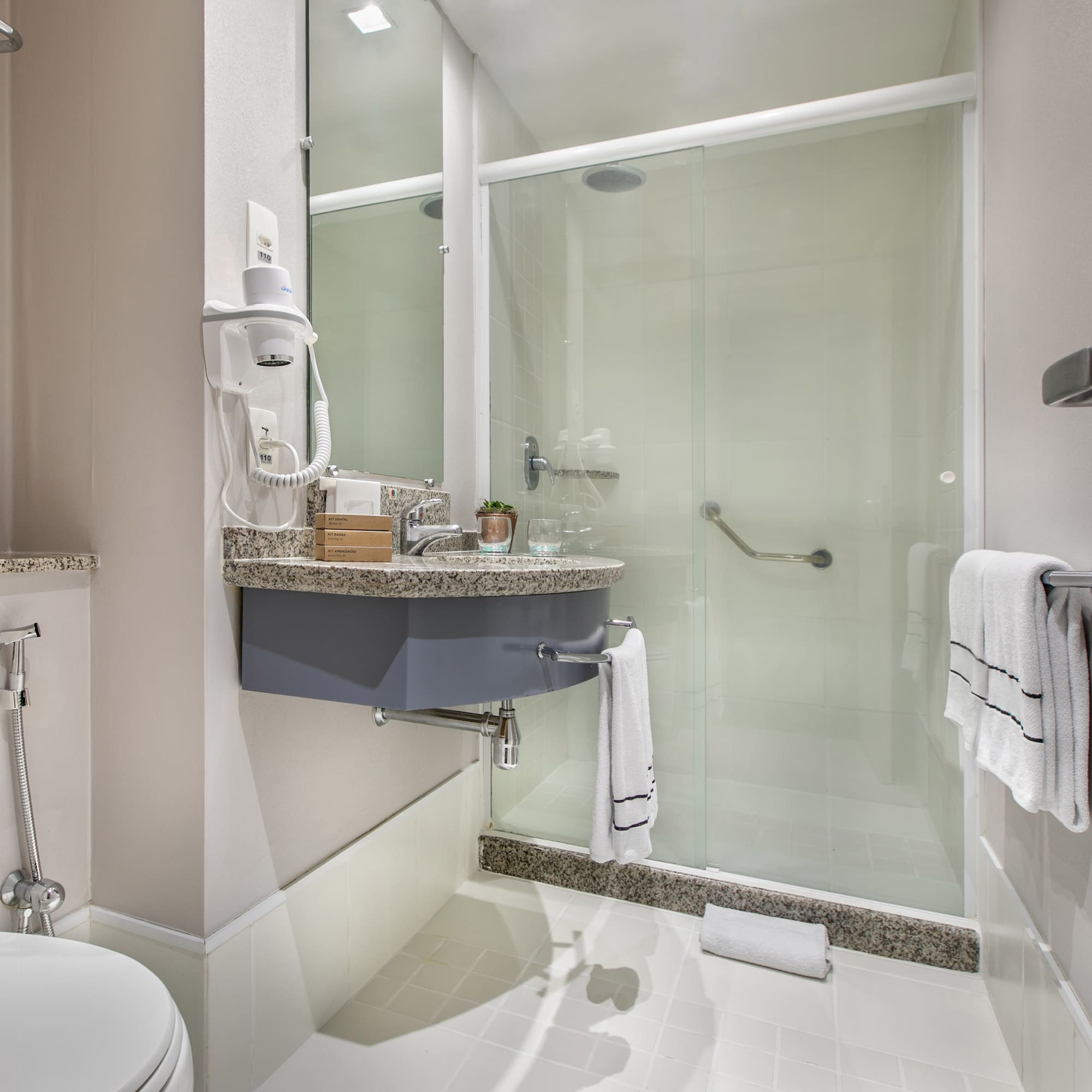 a bathroom with a glass shower door