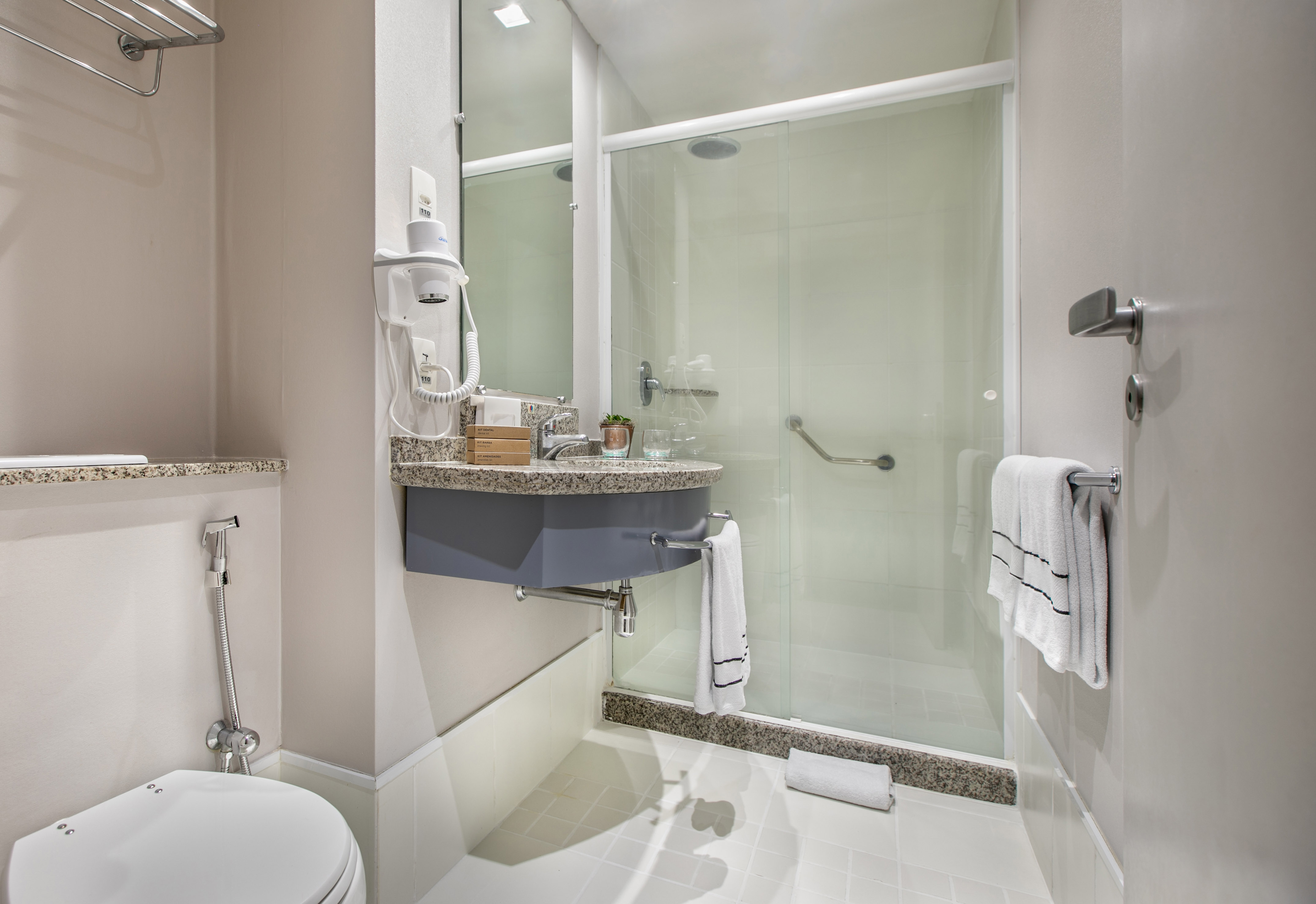 a bathroom with a glass shower door