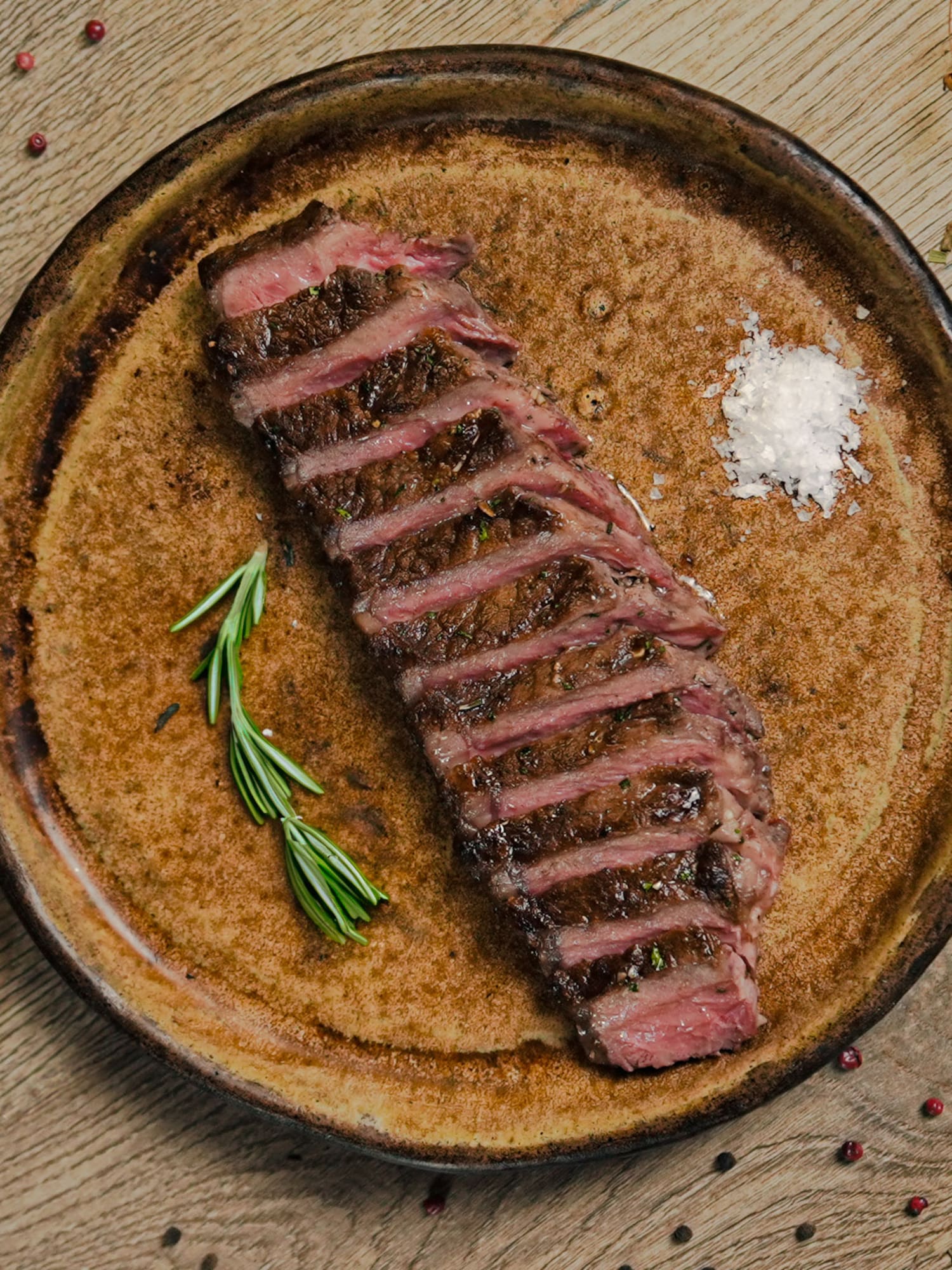 a plate of steak with spices and herbs