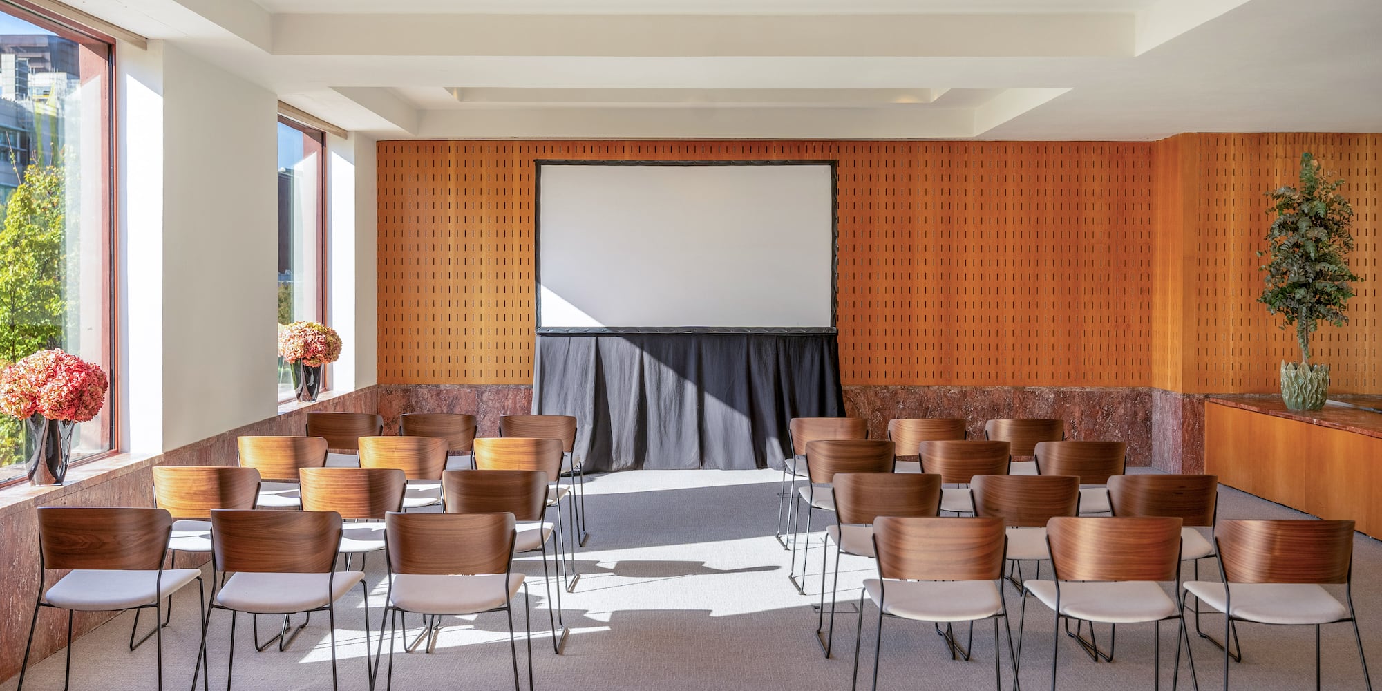 a room with chairs and a projector screen