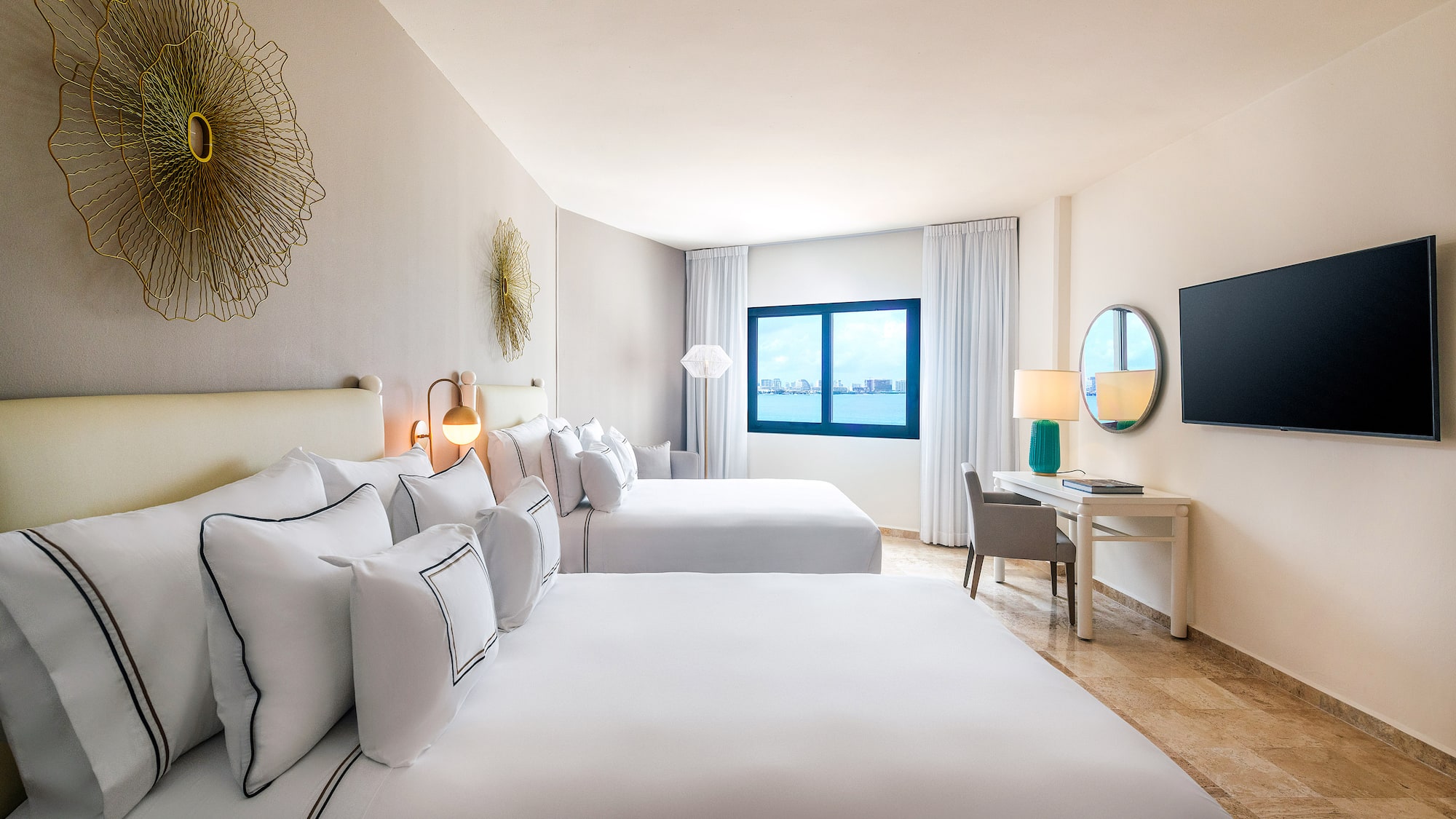 a room with two beds and a television