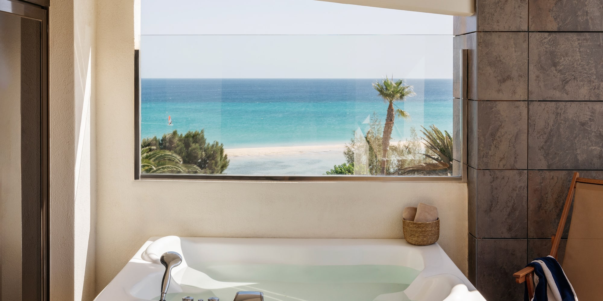 a bathtub with a view of the ocean