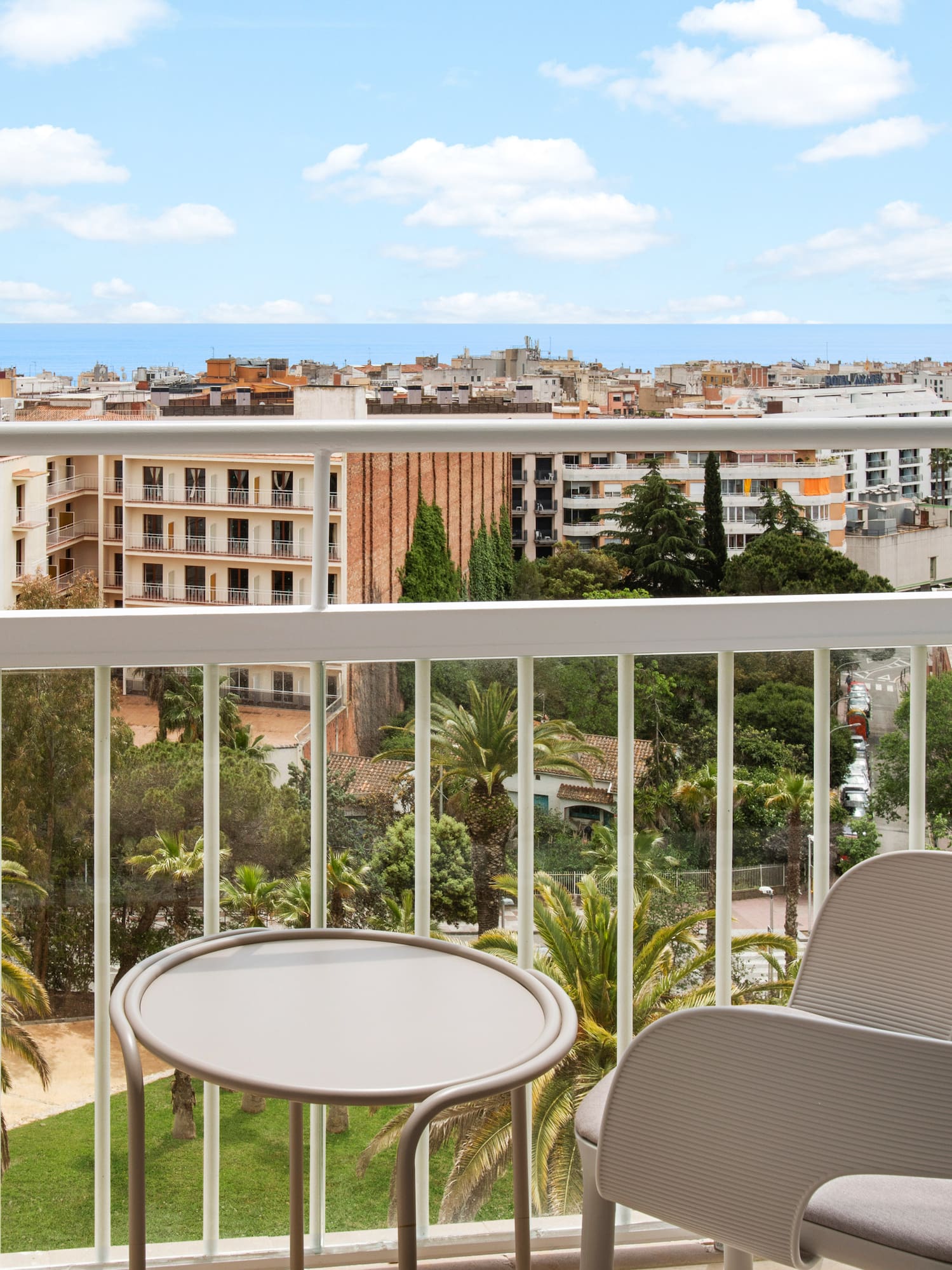 a balcony with chairs and a table