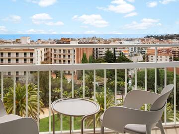 a balcony with chairs and a table