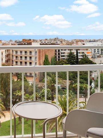 a balcony with chairs and a table