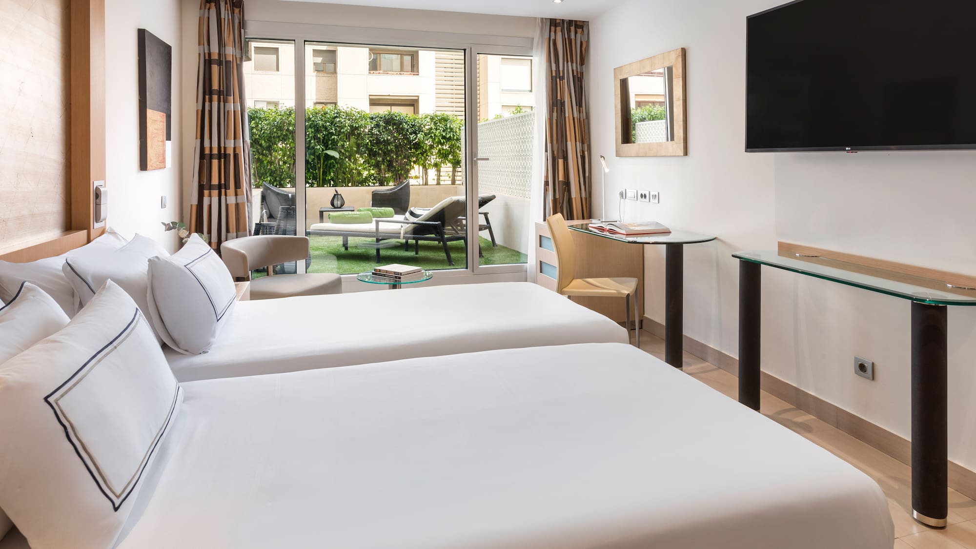 a room with two beds and a television