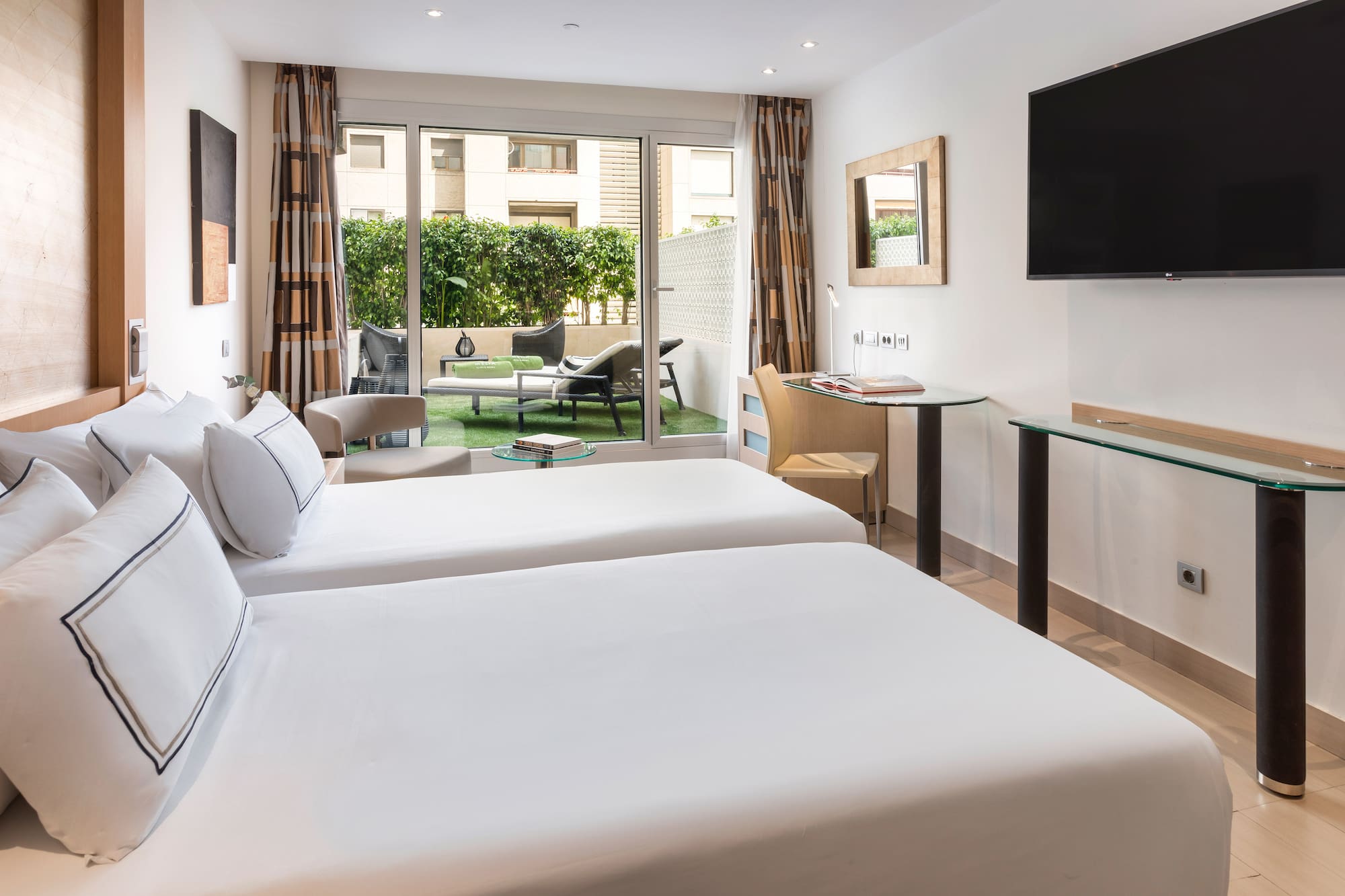 a room with two beds and a television