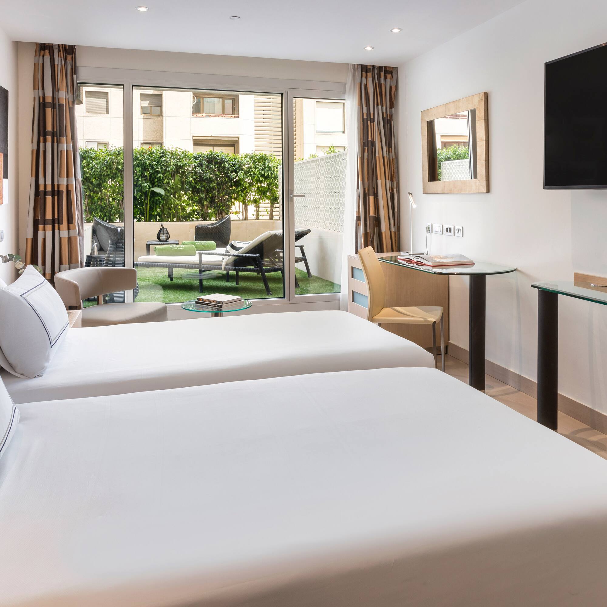 a room with two beds and a television