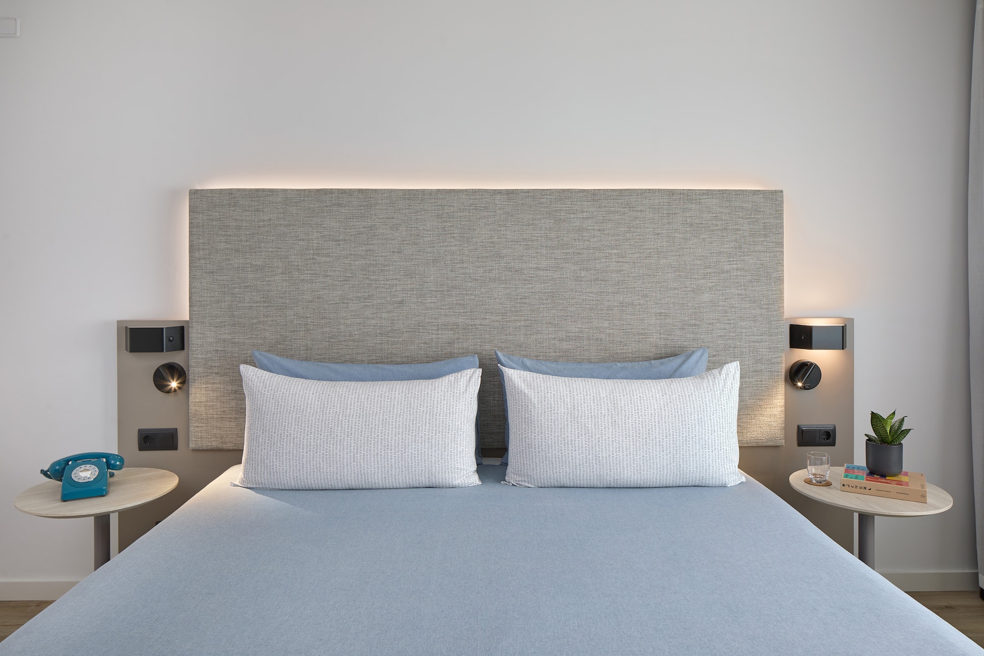 a bed with a headboard and a lamp