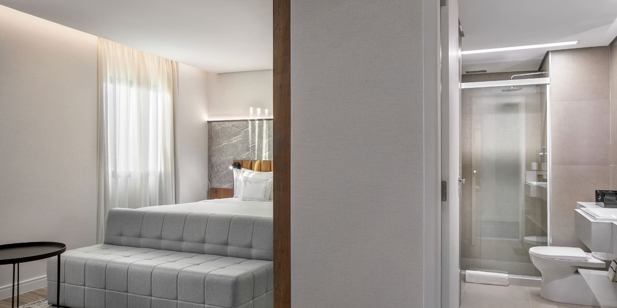 a bedroom with a bed and a shower