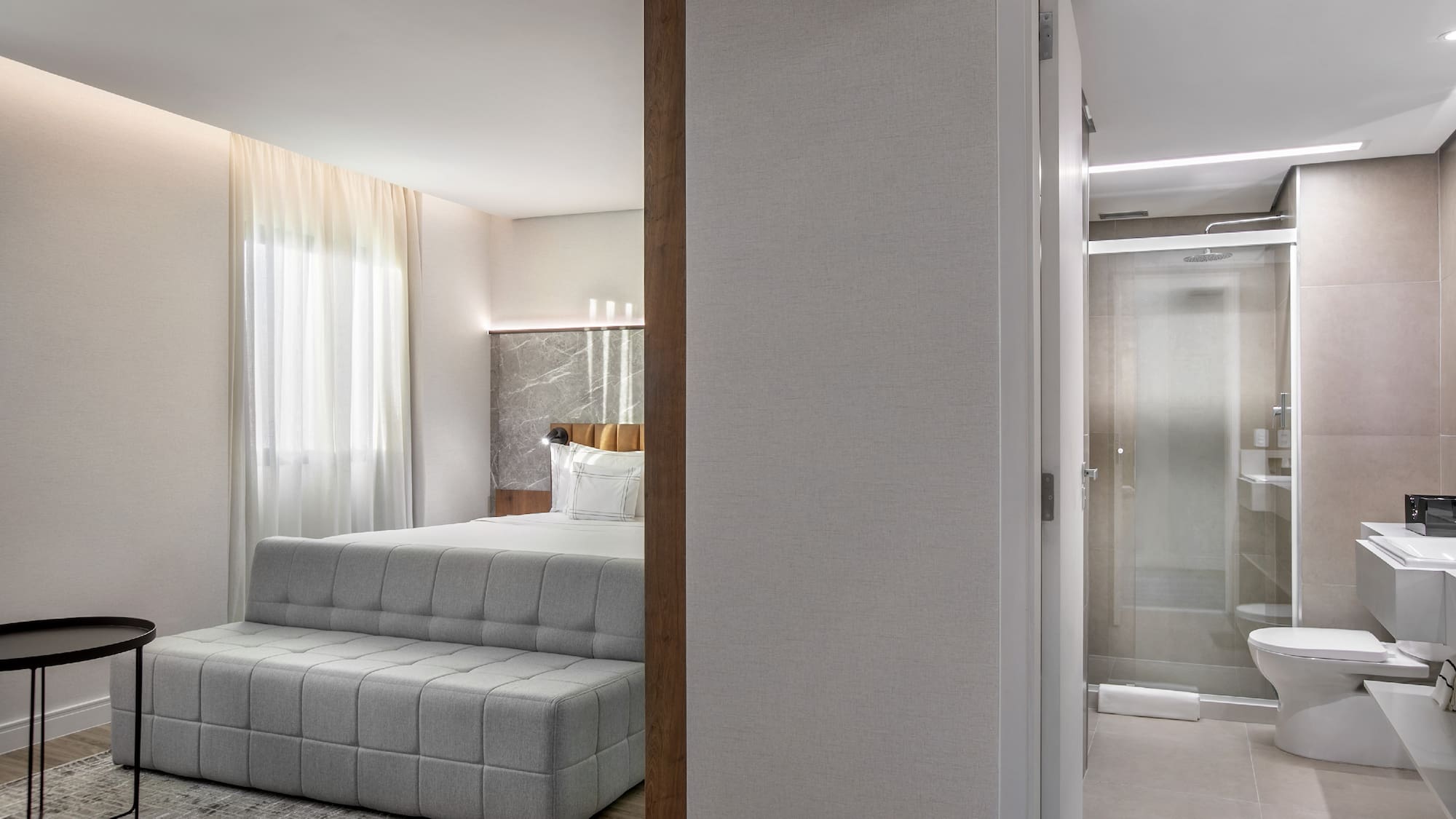 a bedroom with a bed and a shower